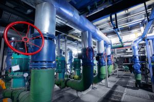 Industrial valve and pipeline system showing alloy and carbon steel components inside a manufacturing facility