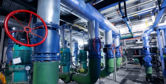 Industrial valve and pipeline system showing alloy and carbon steel components inside a manufacturing facility
