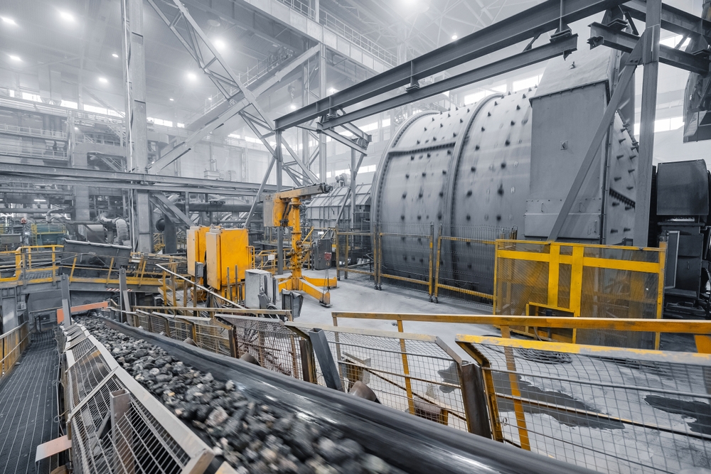 Grinding ball mill operates with mineral ore at plant for copper and gold concentrate