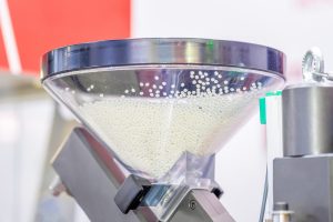 A transparent hopper with polypropylene granules